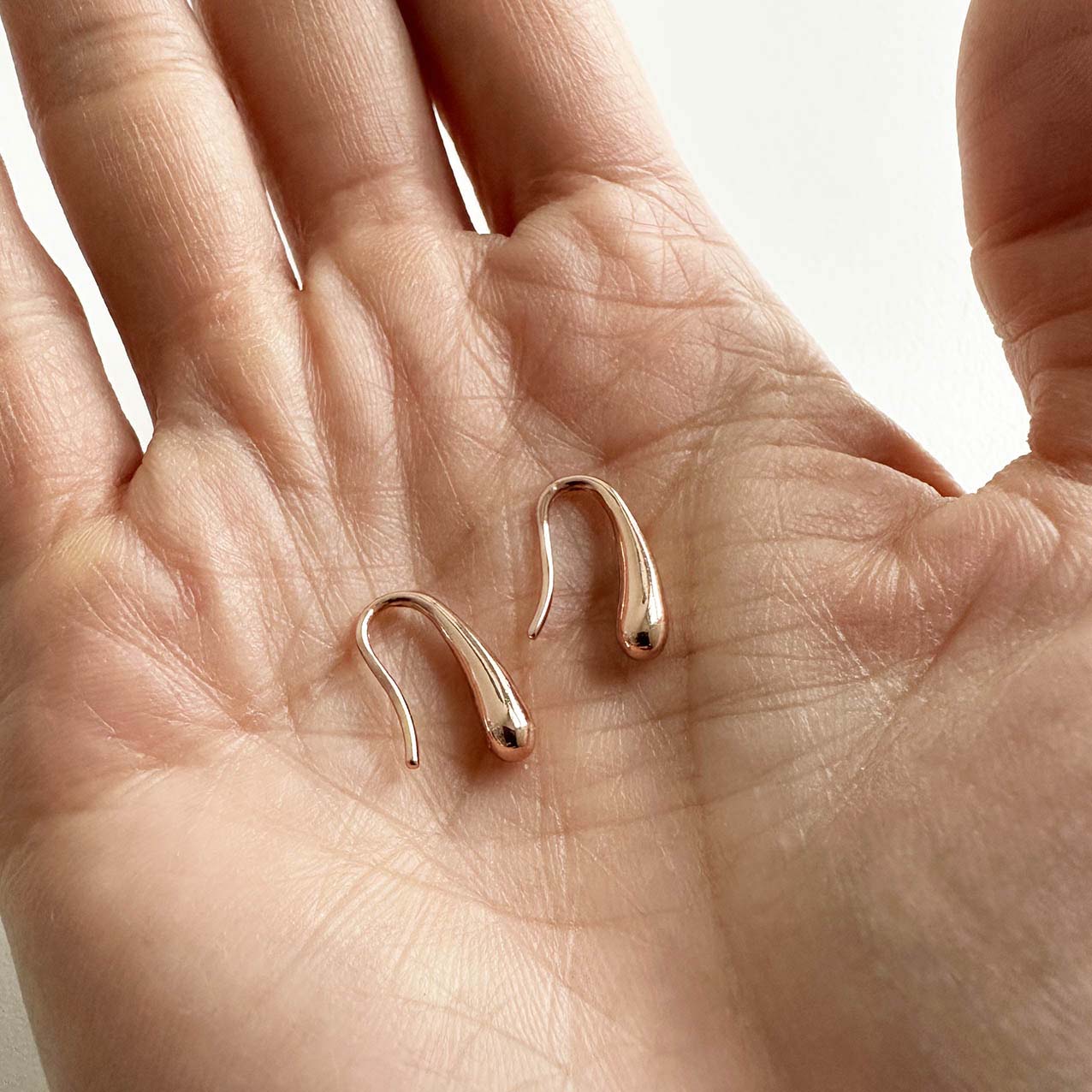 jullie drop earrings 18k rose gold plated sterling silver on hand