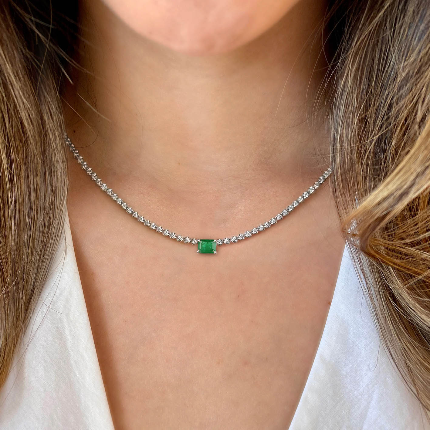 4ct emerald diamond tennis necklact in 18k white gold on neck