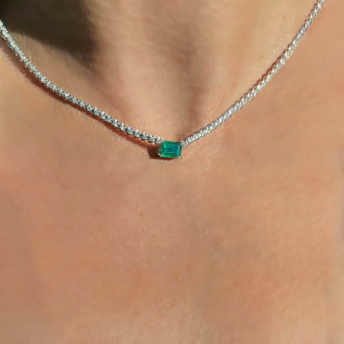 4ct emerald diamond tennis necklact in 18k white gold on neck