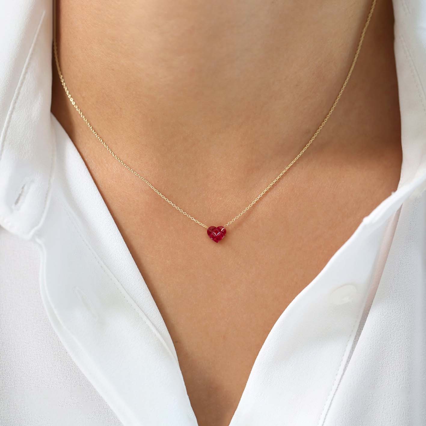 0.5ct ruby by heart necklace in 18k gold on neck