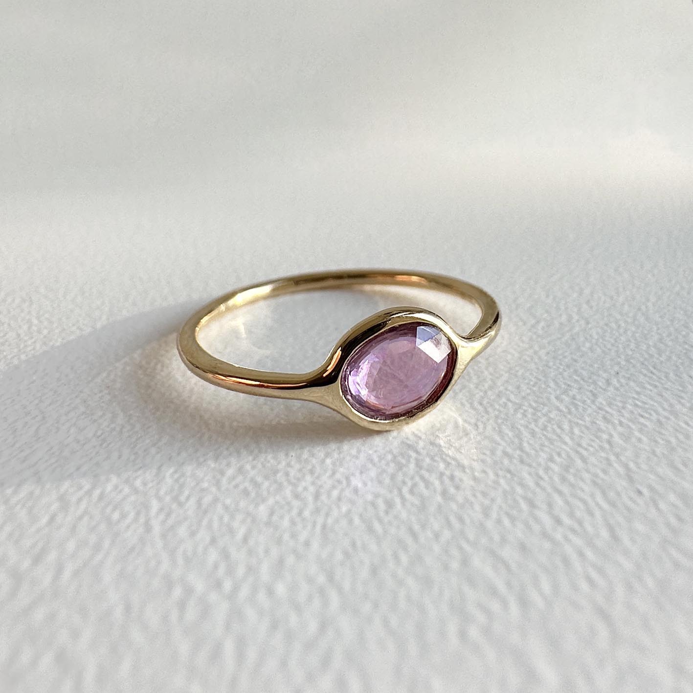 pink 058ct sapphire ring 18k gold on table