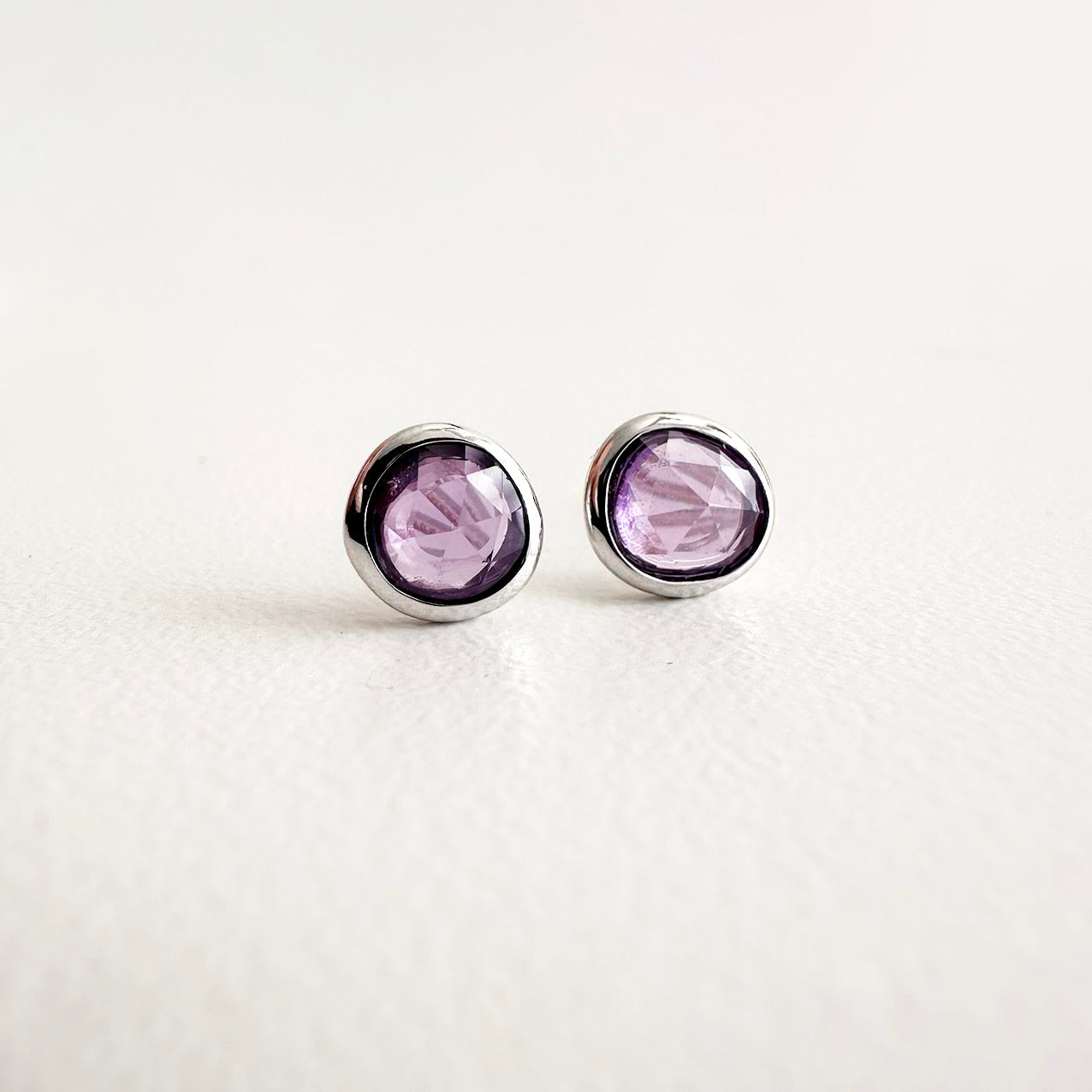 love more purple sapphire earrings 18k white gold on table
