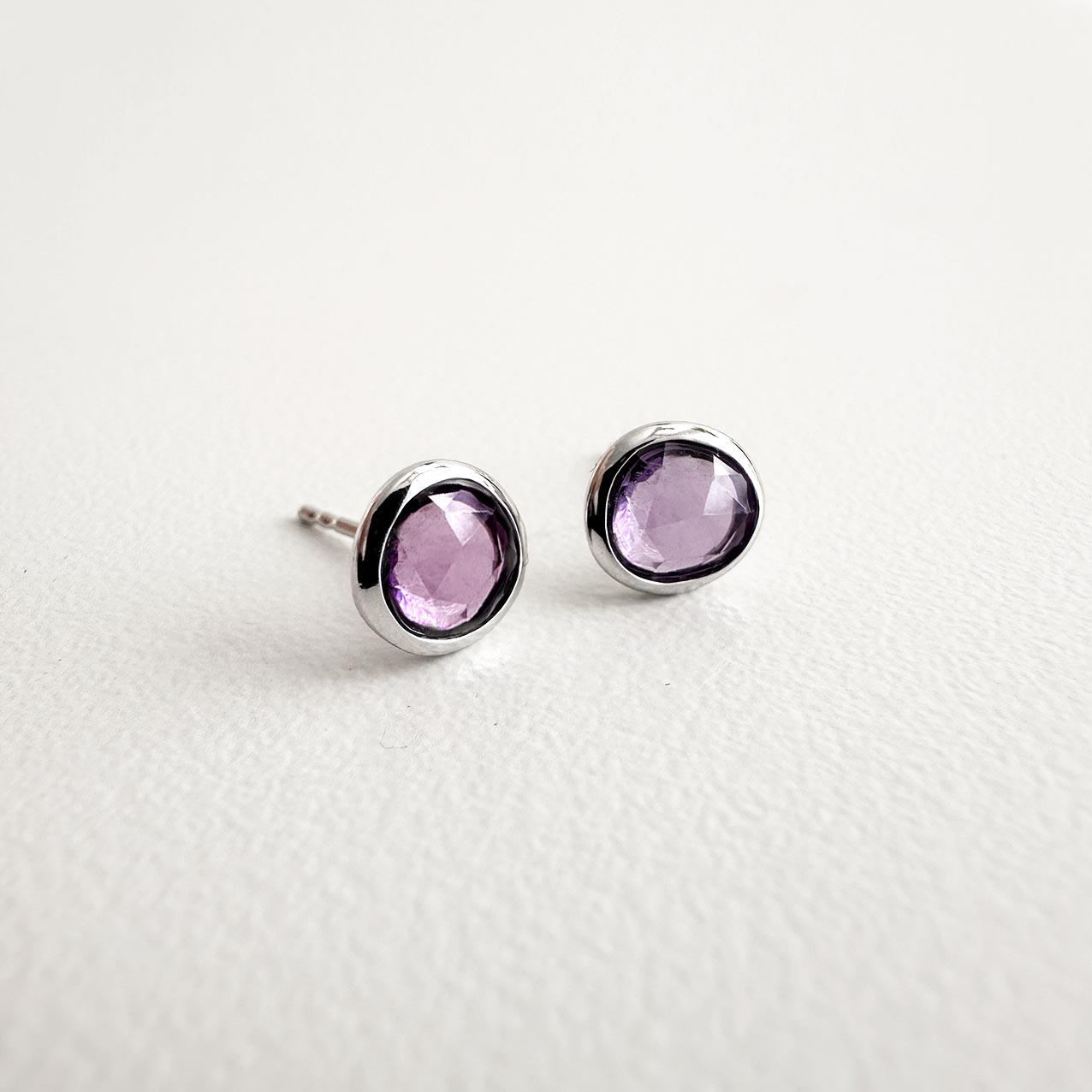 love more purple sapphire earrings 18k white gold on table