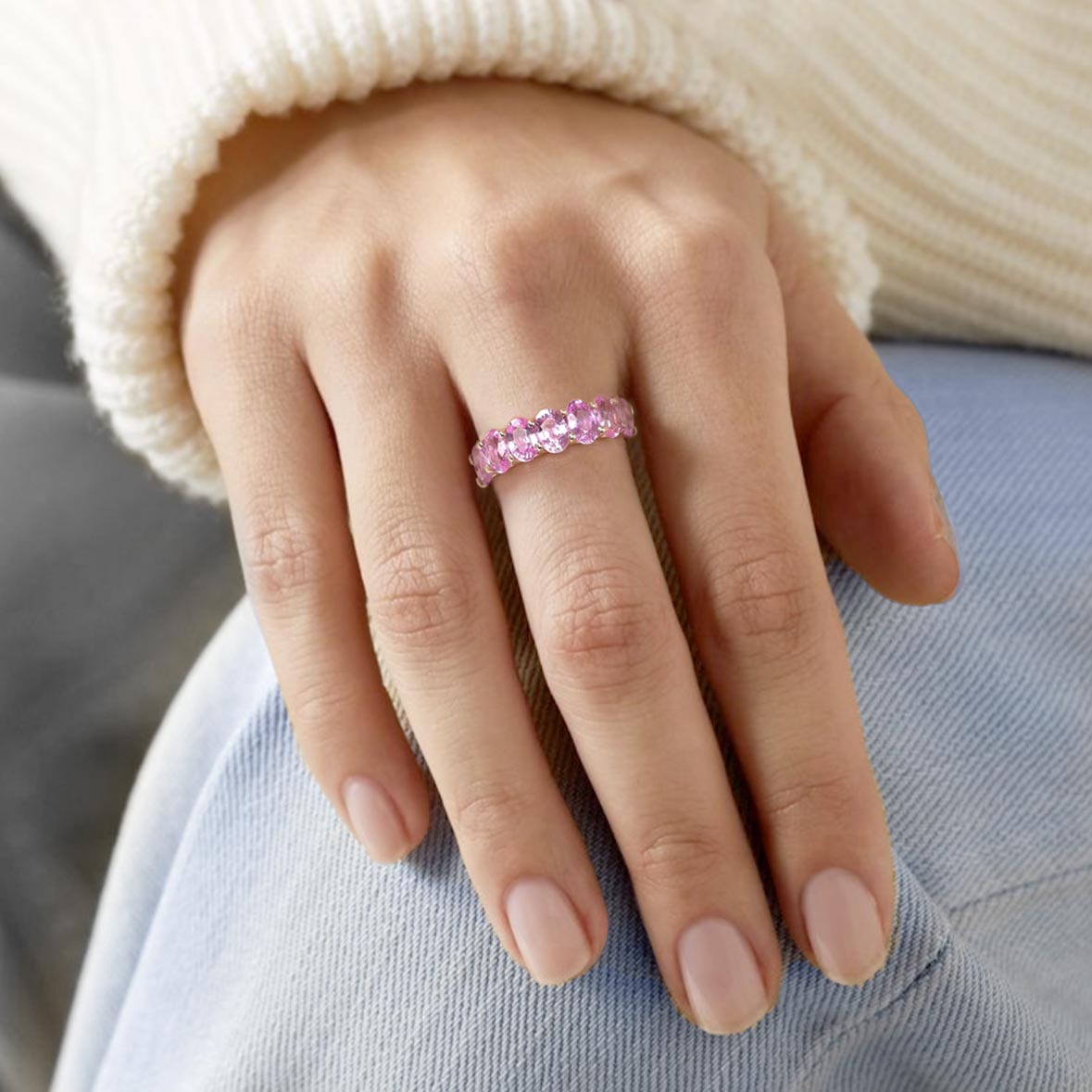 seven stone oval pink sapphire ring in 18k gold on hand