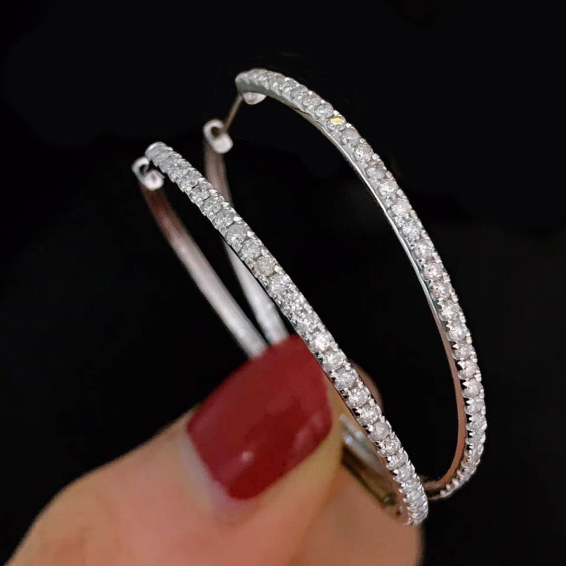 0.6ct diamond hoop earrings in 18k white gold on hand