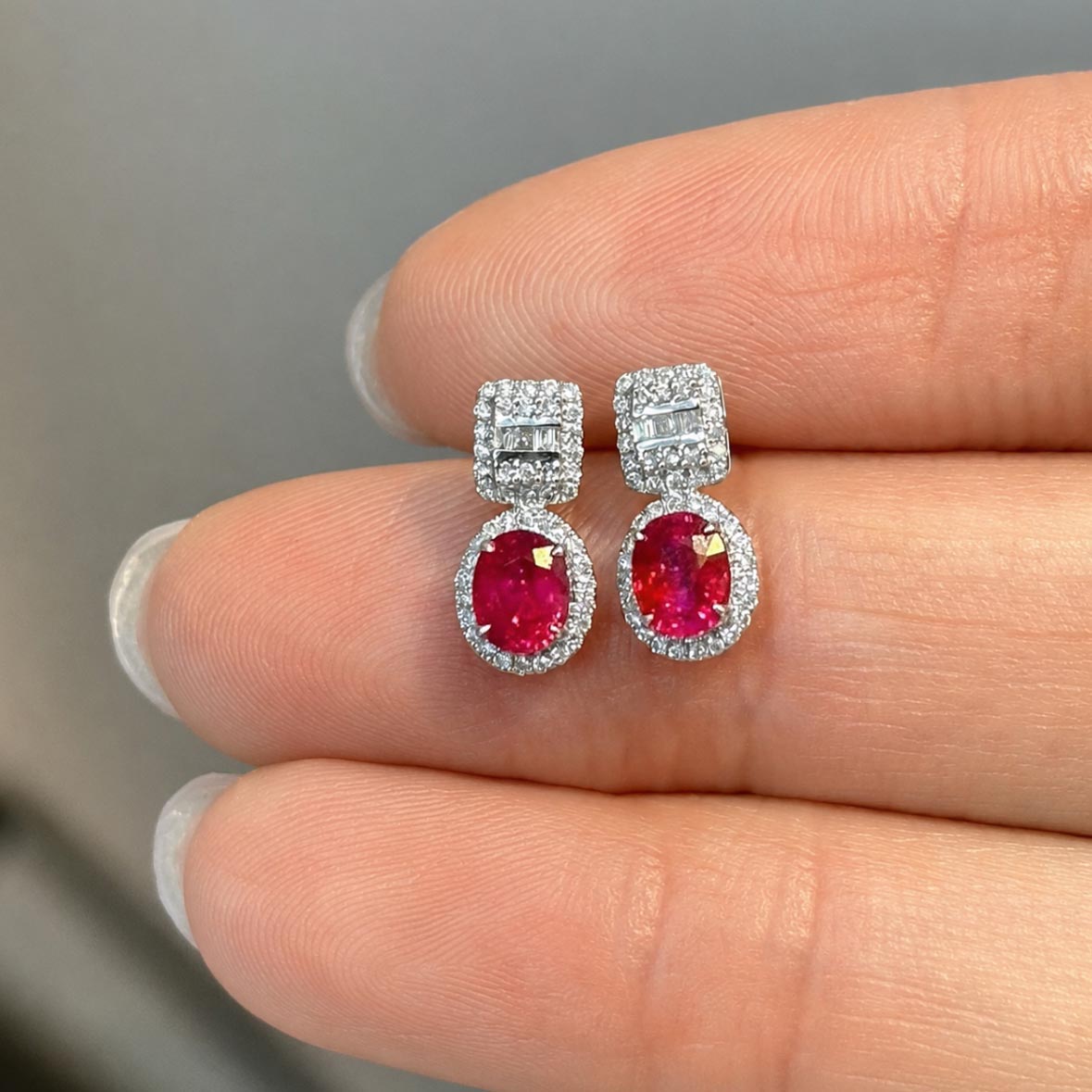 1.0ct ruby earrings with diamonds in 18k white gold on hand