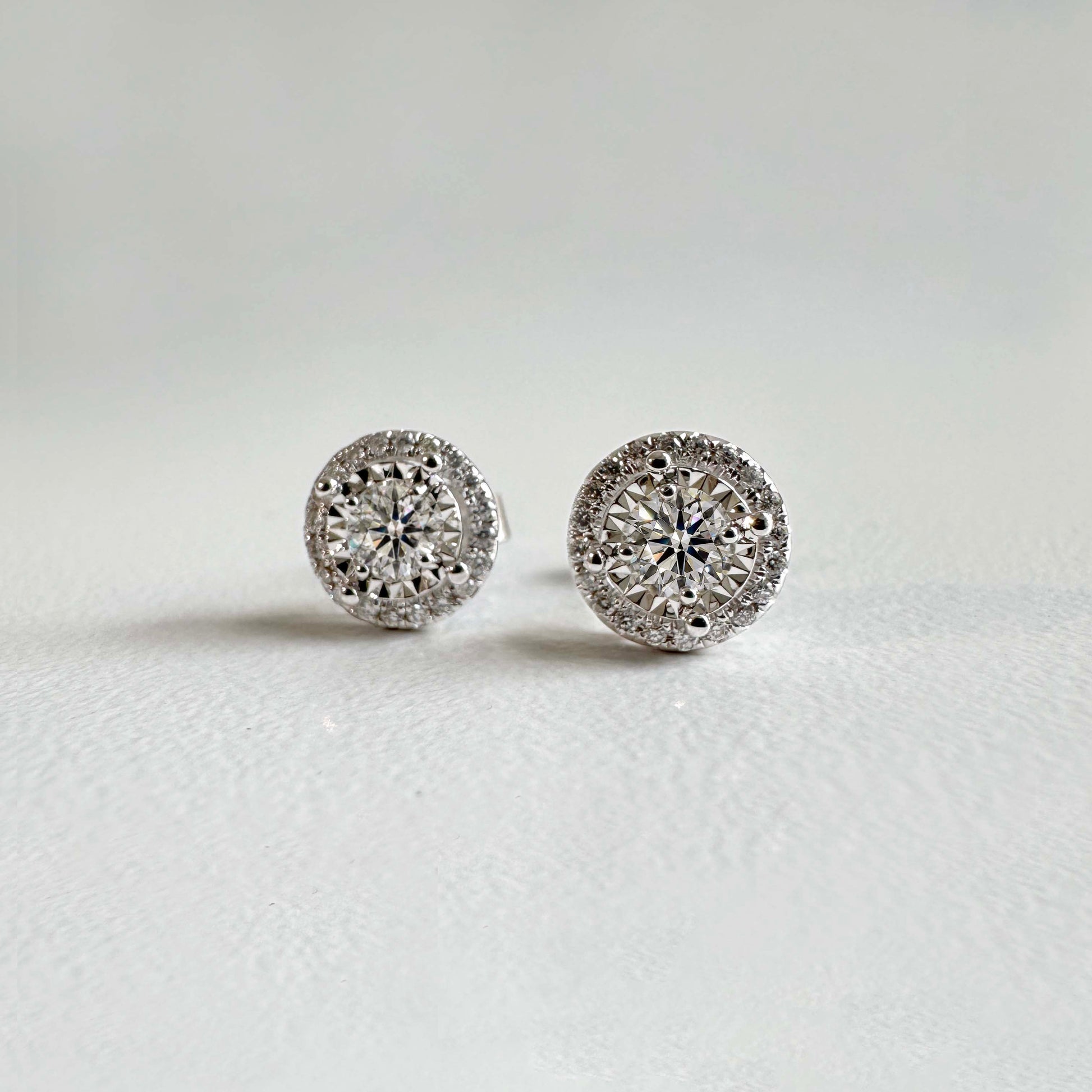 embrace 0.5ct round diamond halo earrings in 18k white gold