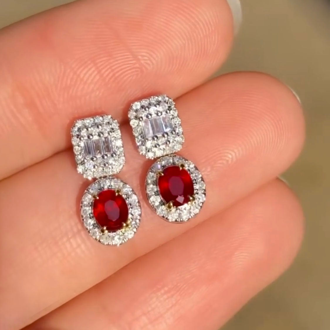 0.81ct ruby earrings with diamonds in 18k white gold on hand