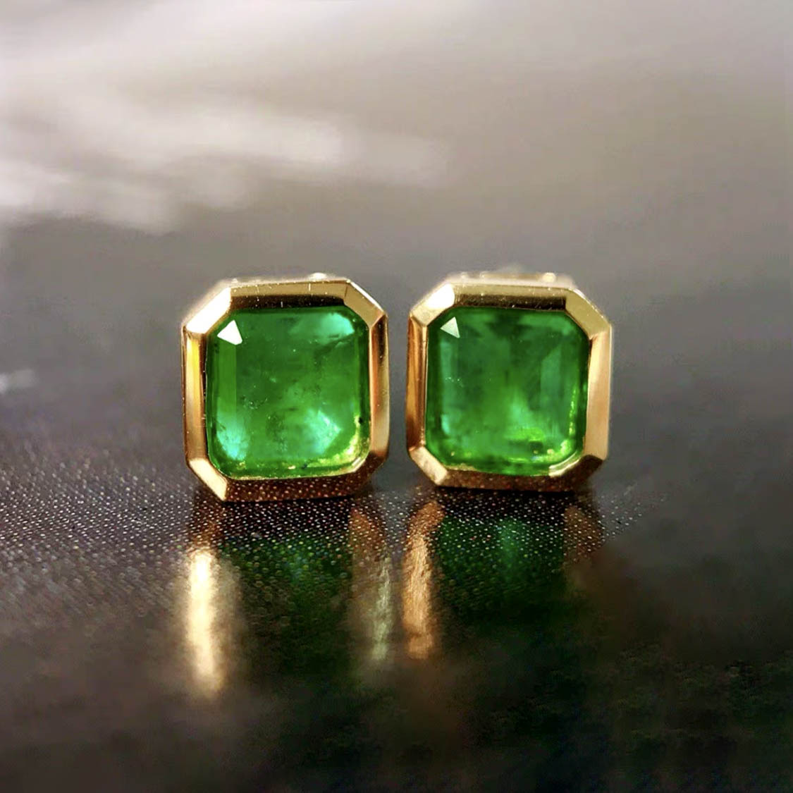 0.87ct bezel set asscher emerald earrings in 18k gold