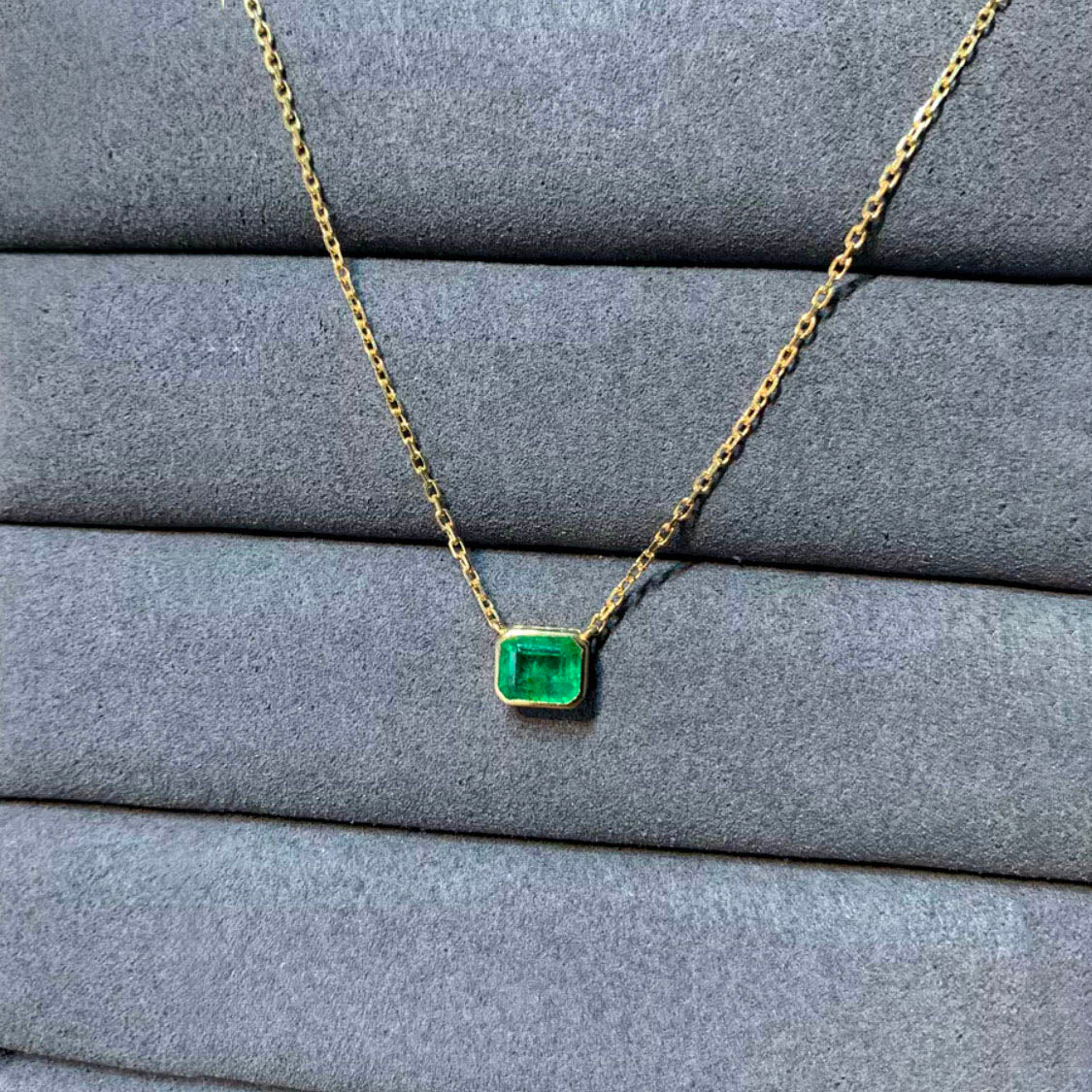 bezel set emerald necklace in 18k gold