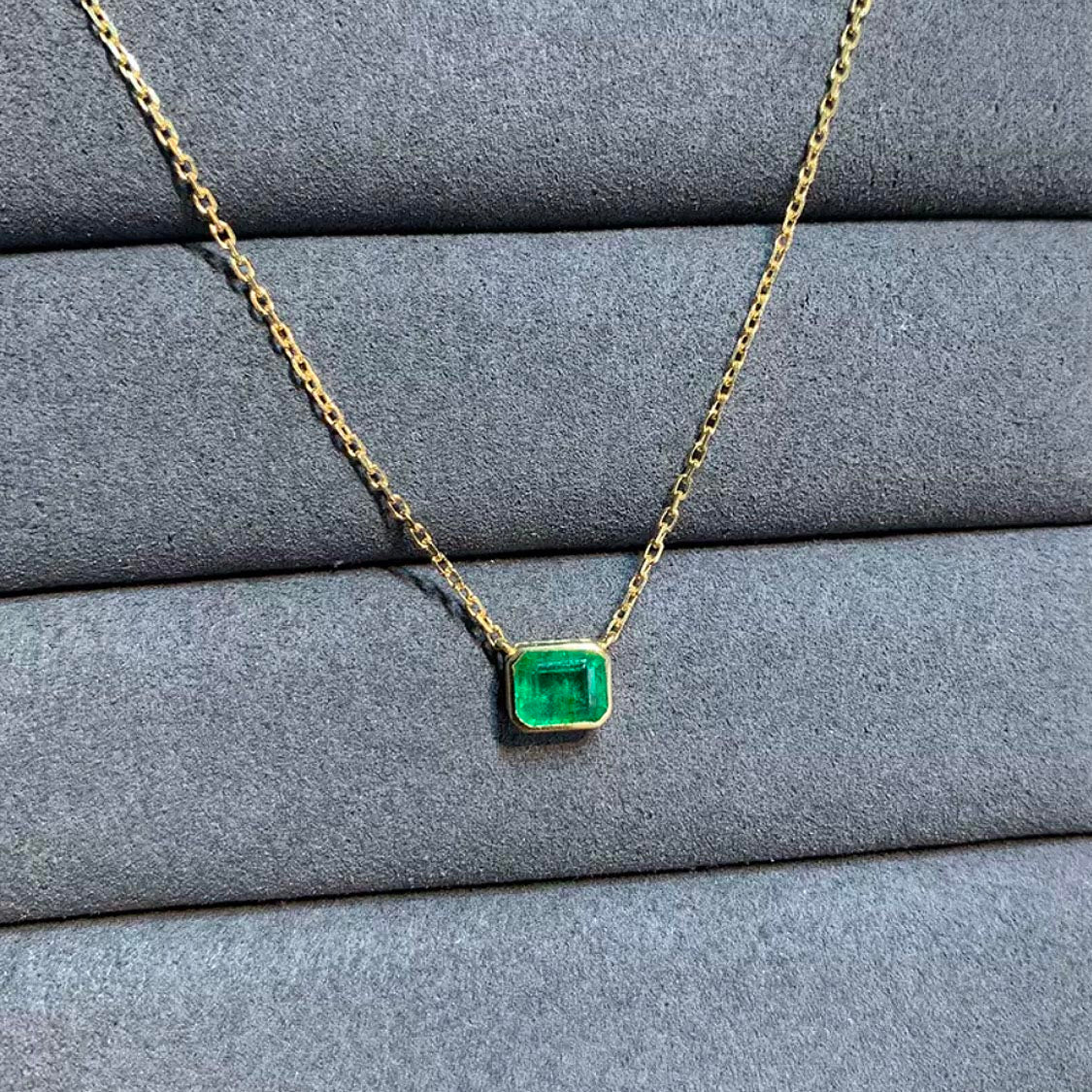 bezel set emerald necklace in 18k gold