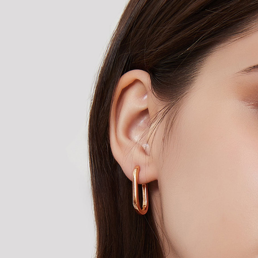 jullie big oval earrings in rose gold plated silver on ear