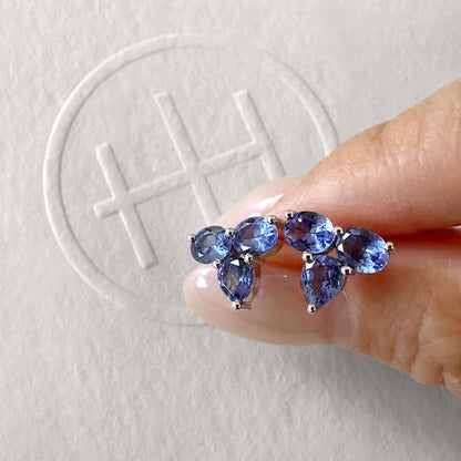 eden small tanzanite earrings in 18k white gold on hand