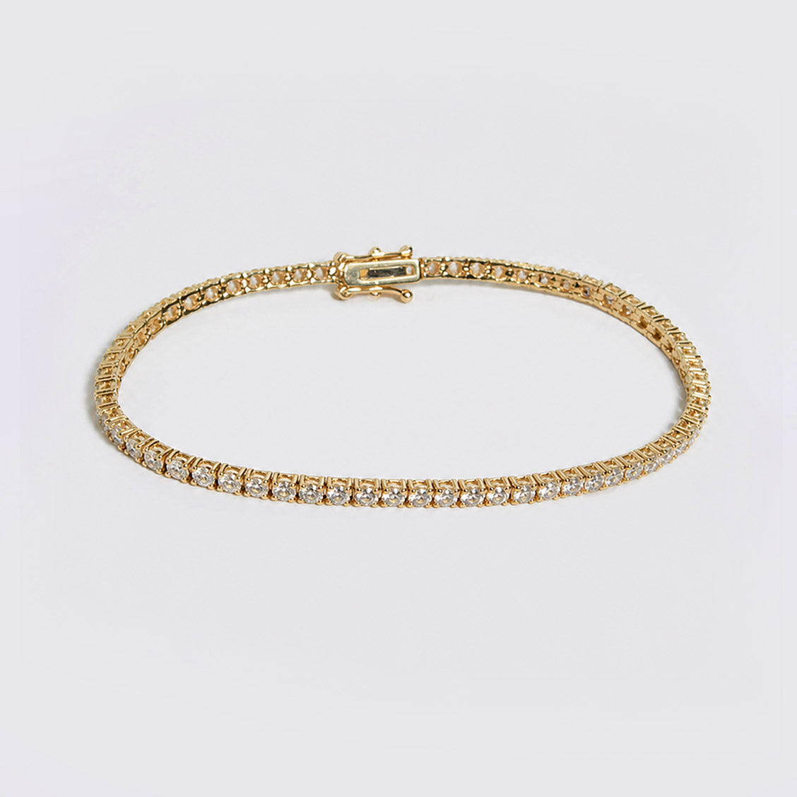embrace 2ct diamond tennis bracelet in 18k gold on table