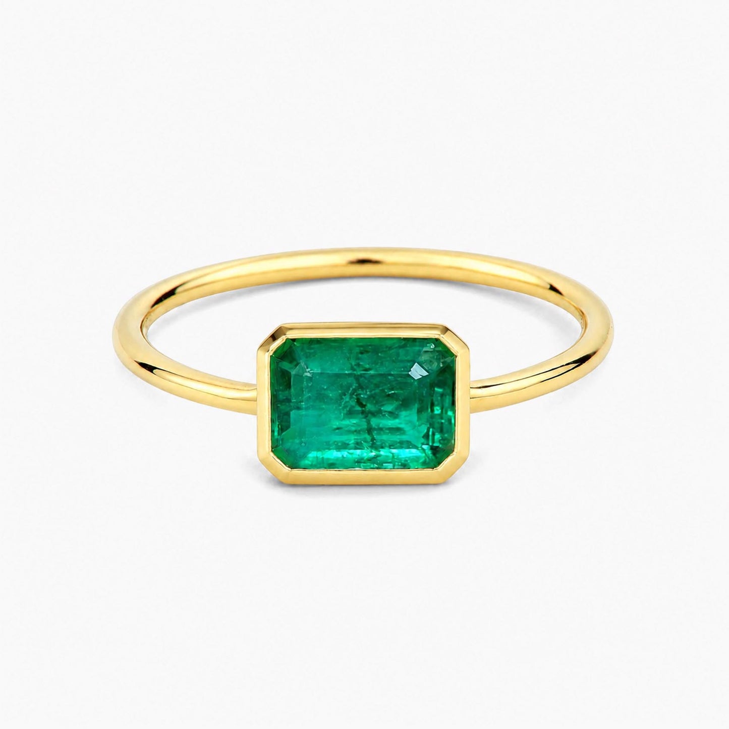1.0ct step cut emerald ring in 18k gold