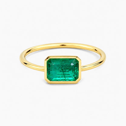 1.0ct step cut emerald ring in 18k gold