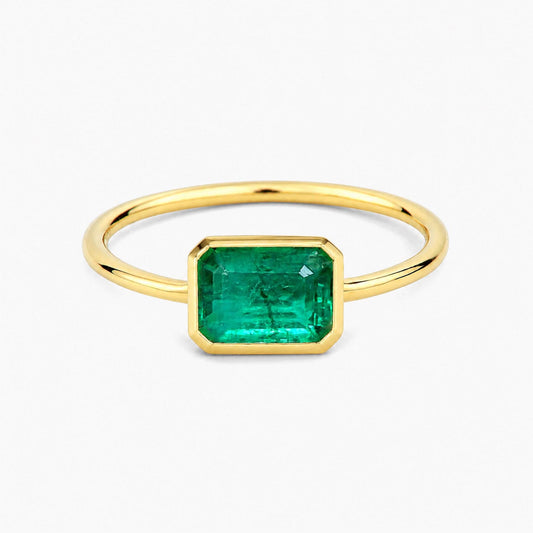 1.0ct step cut emerald ring in 18k gold