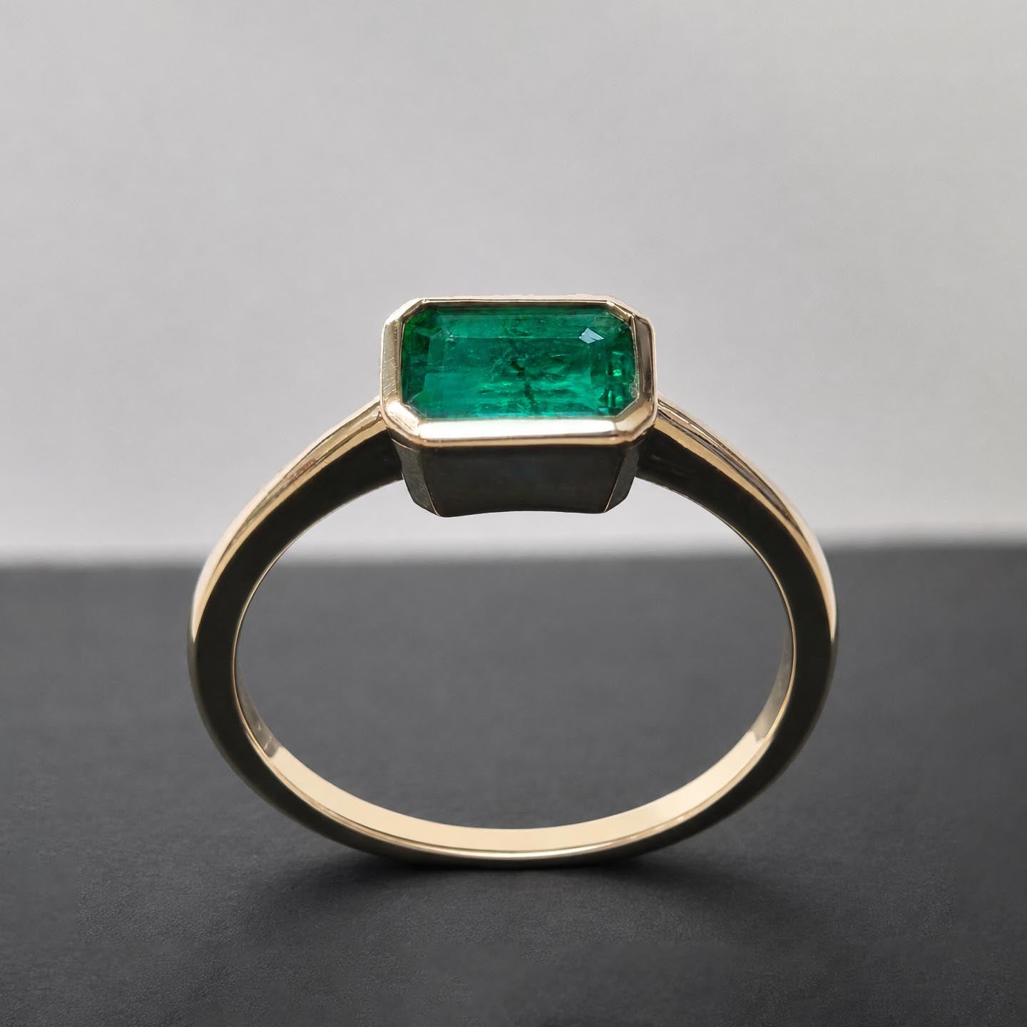 1.0ct step cut emerald ring in 18k gold front view