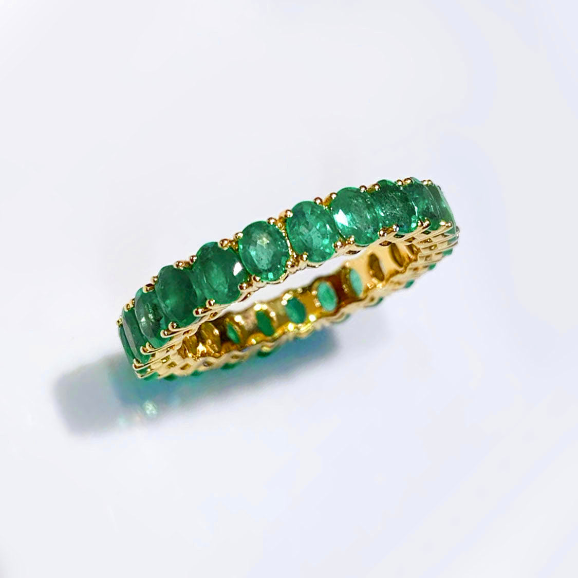 3.0ct oval cut emerald eternity ring in 18k gold