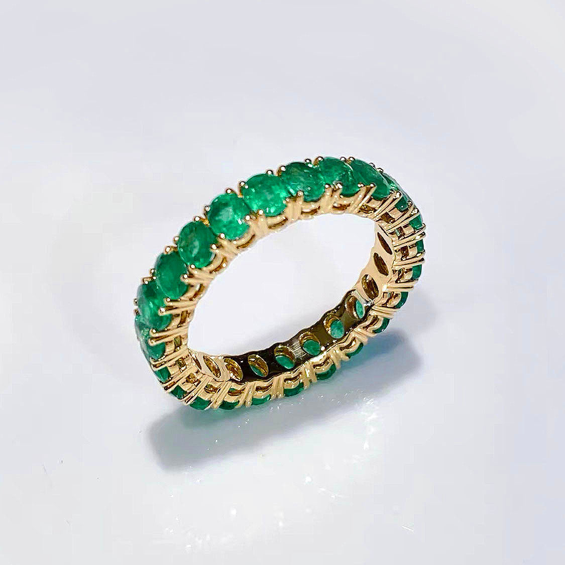 3.0ct oval cut emerald eternity ring in 18k gold