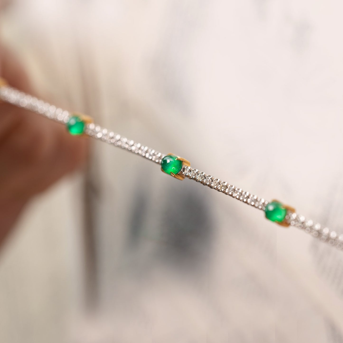 emerald diamond tennis bracelet in 19k white gold