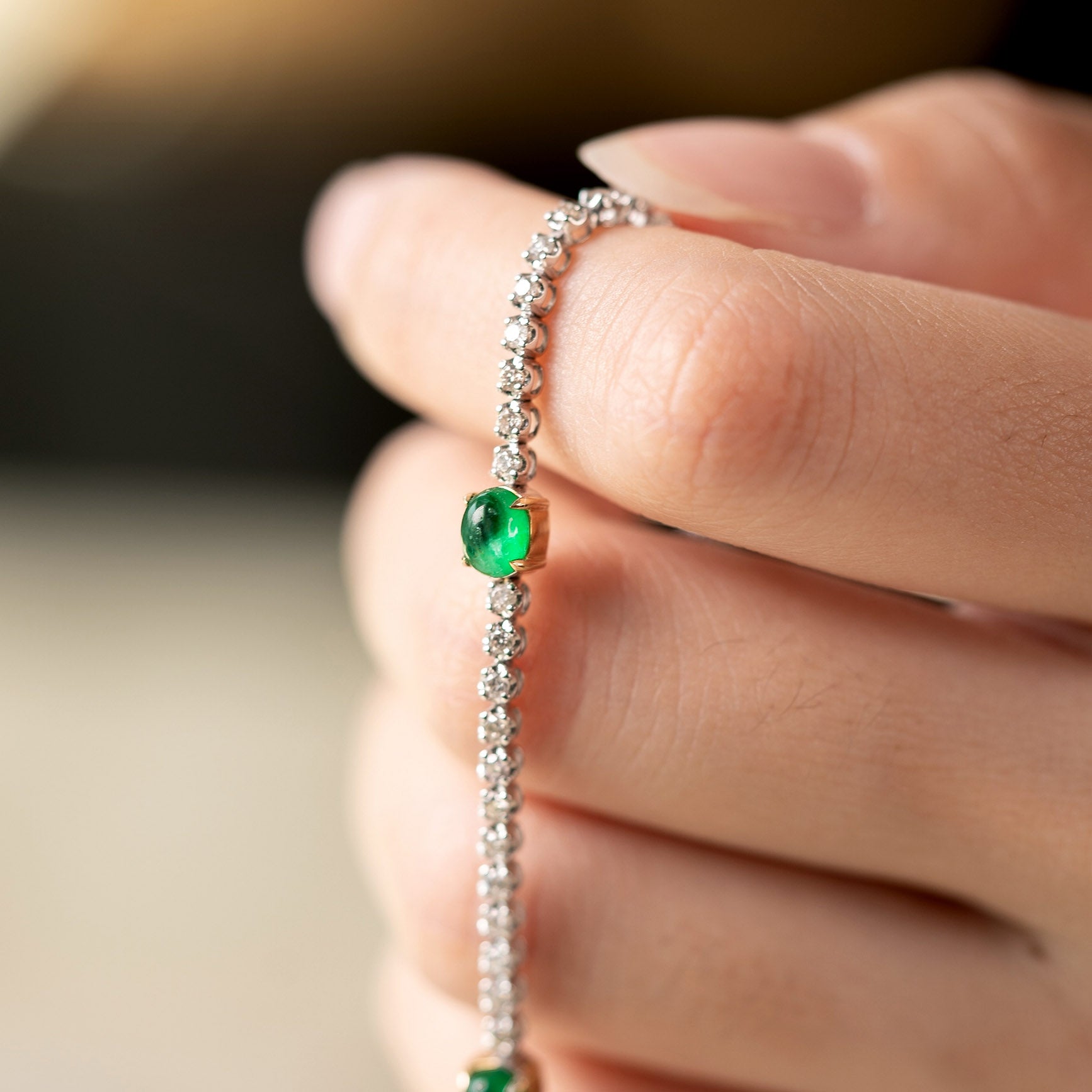 emerald diamond tennis bracelet in 19k white gold on hand
