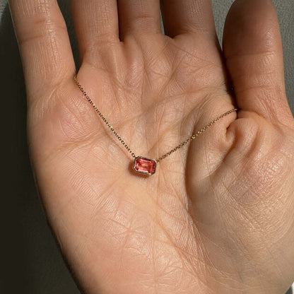 love more bezel set padparadscha sapphire necklace in 18k gold on hand