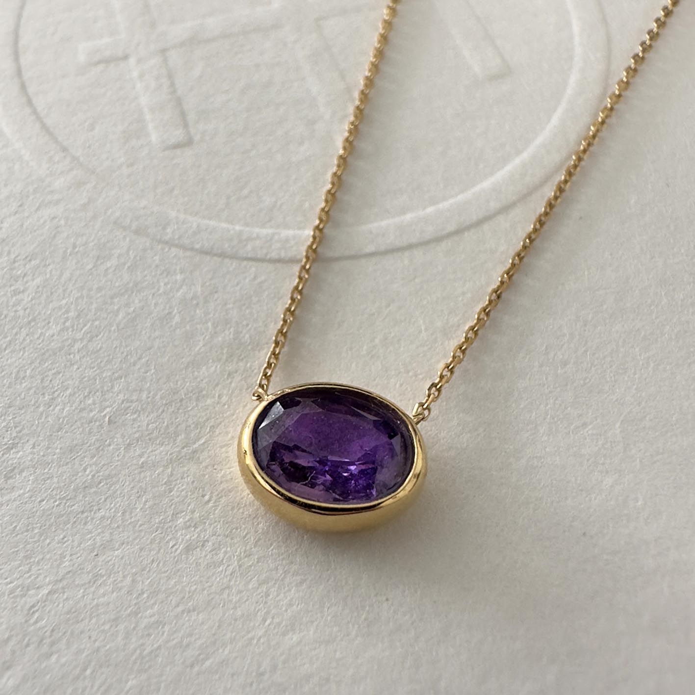 love more bezel set oval purple sapphire necklace in 18k gold close up