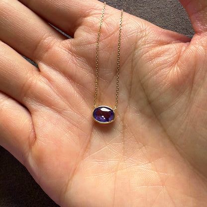 love more bezel set oval purple sapphire necklace in 18k gold on hand
