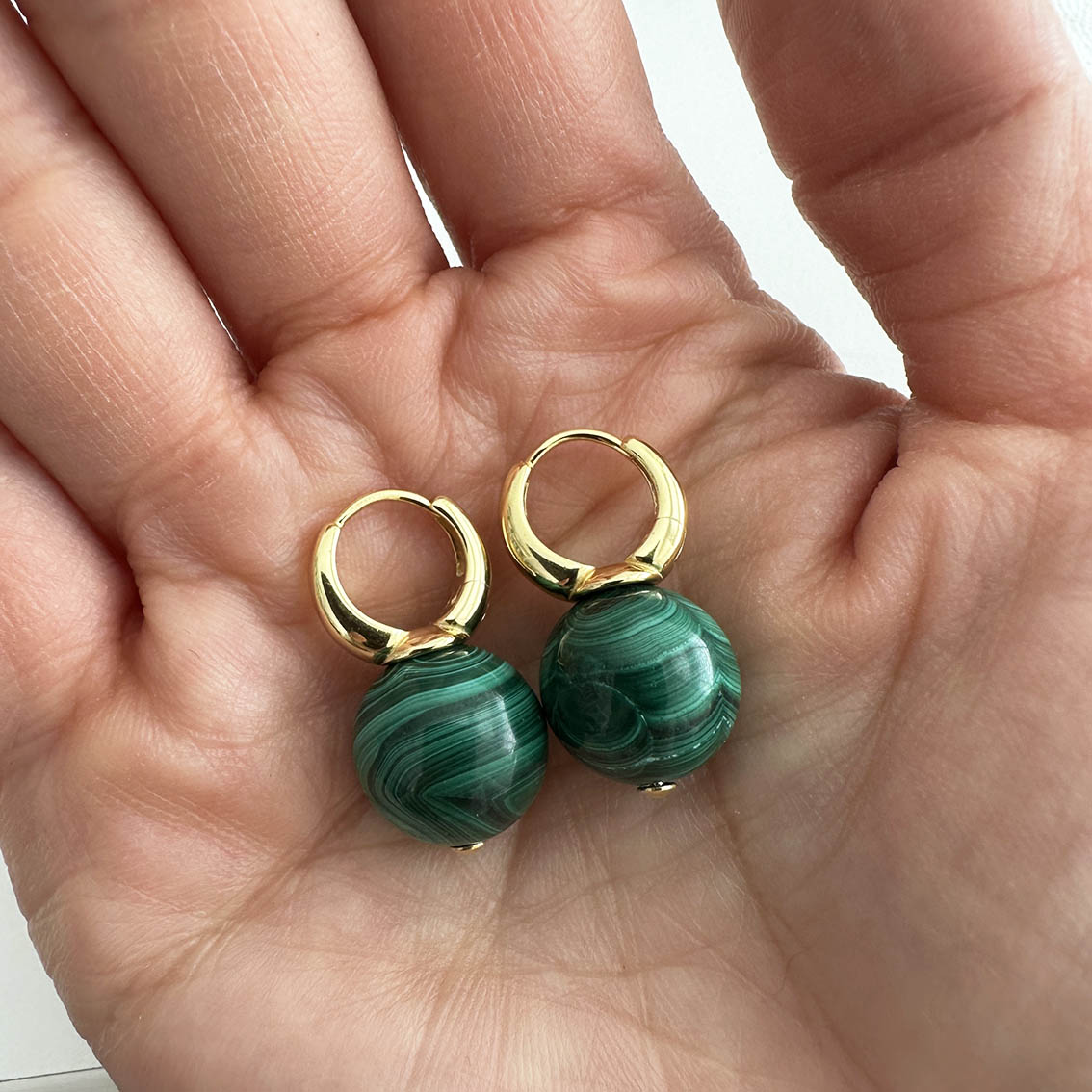 jullie green malachite ball earrings in 18k gold plated sterling silver on hand