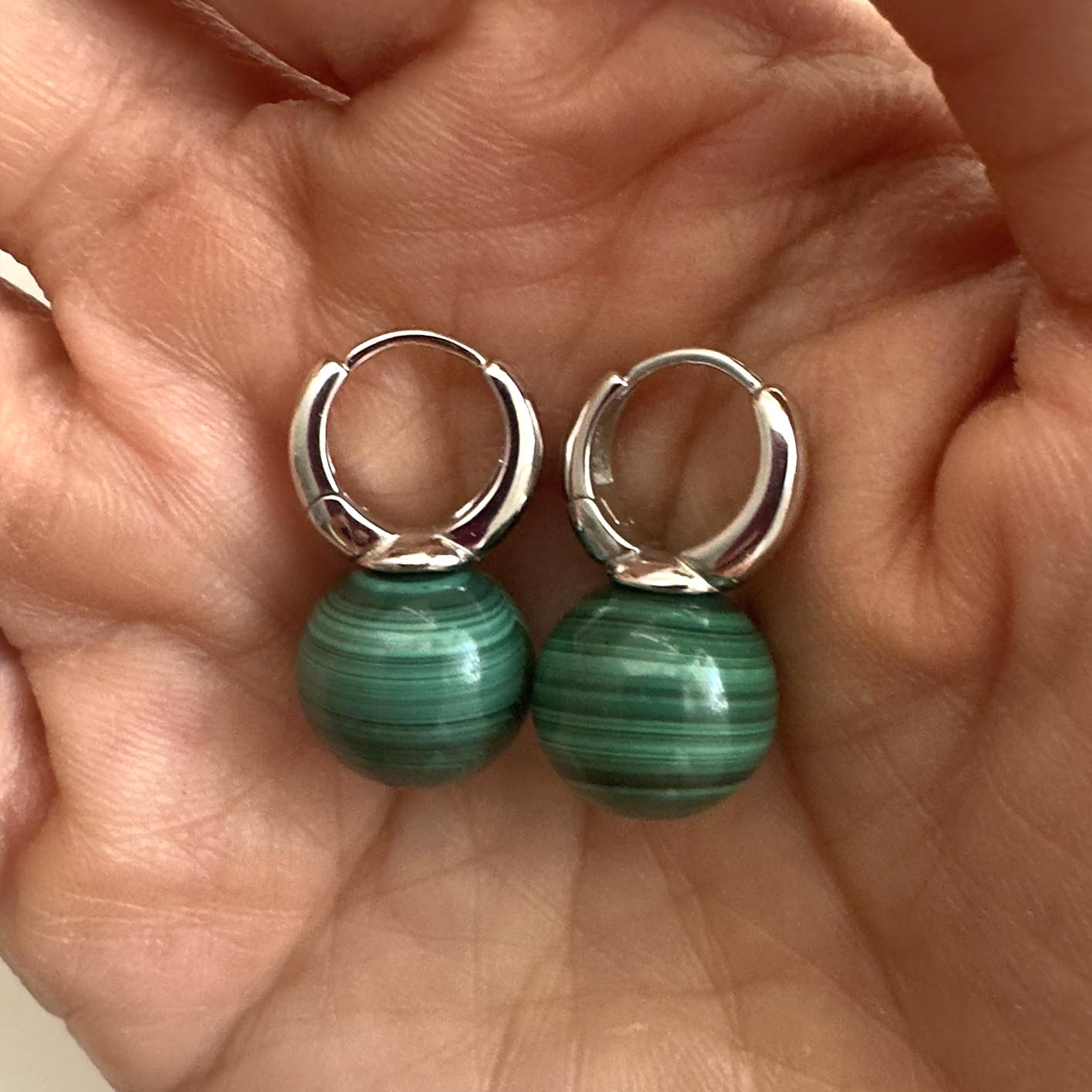 jullie green malachite ball earrings in sterling silver on hand