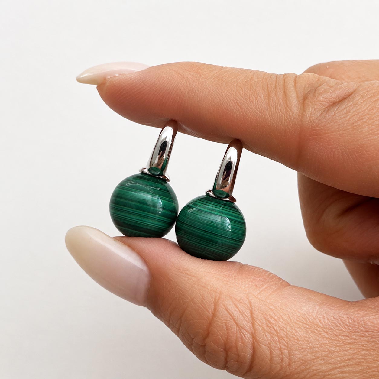 jullie green malachite ball earrings in sterling silver on hand