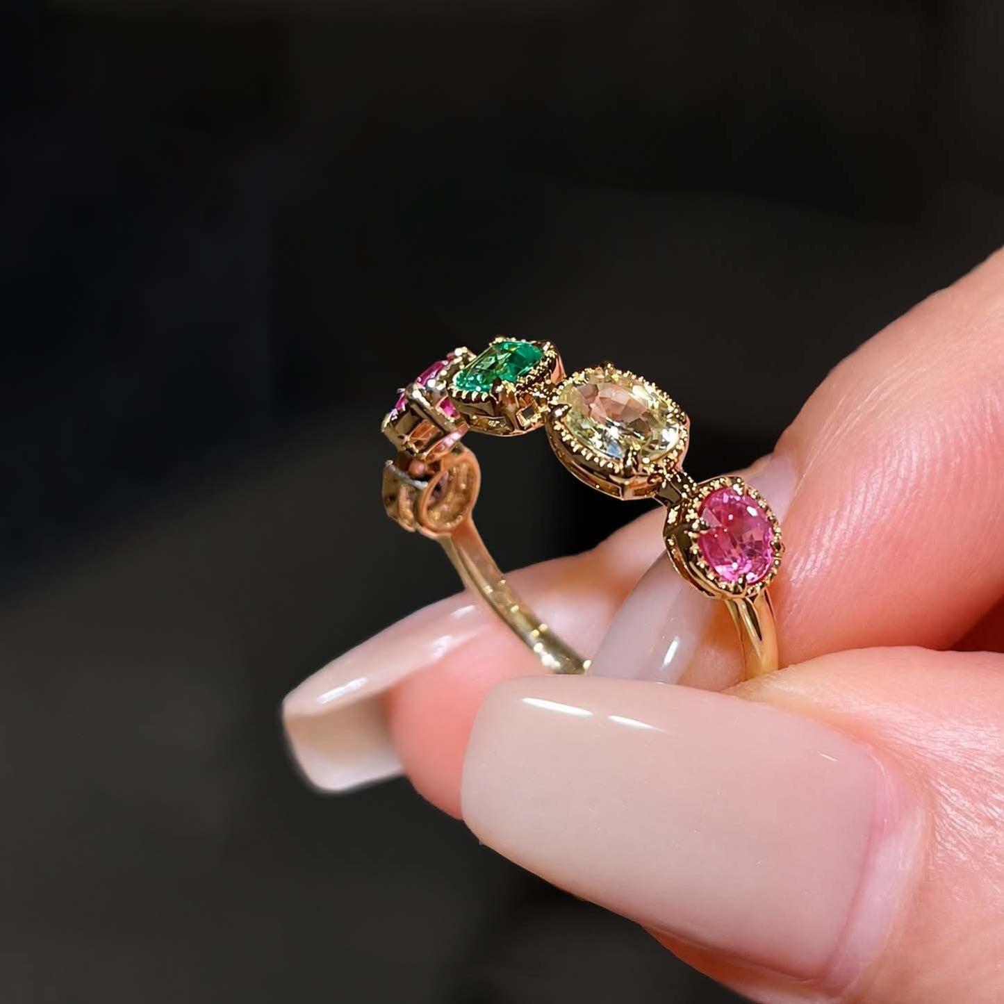 mixed cut colored gemstones ring in 18k gold side view
