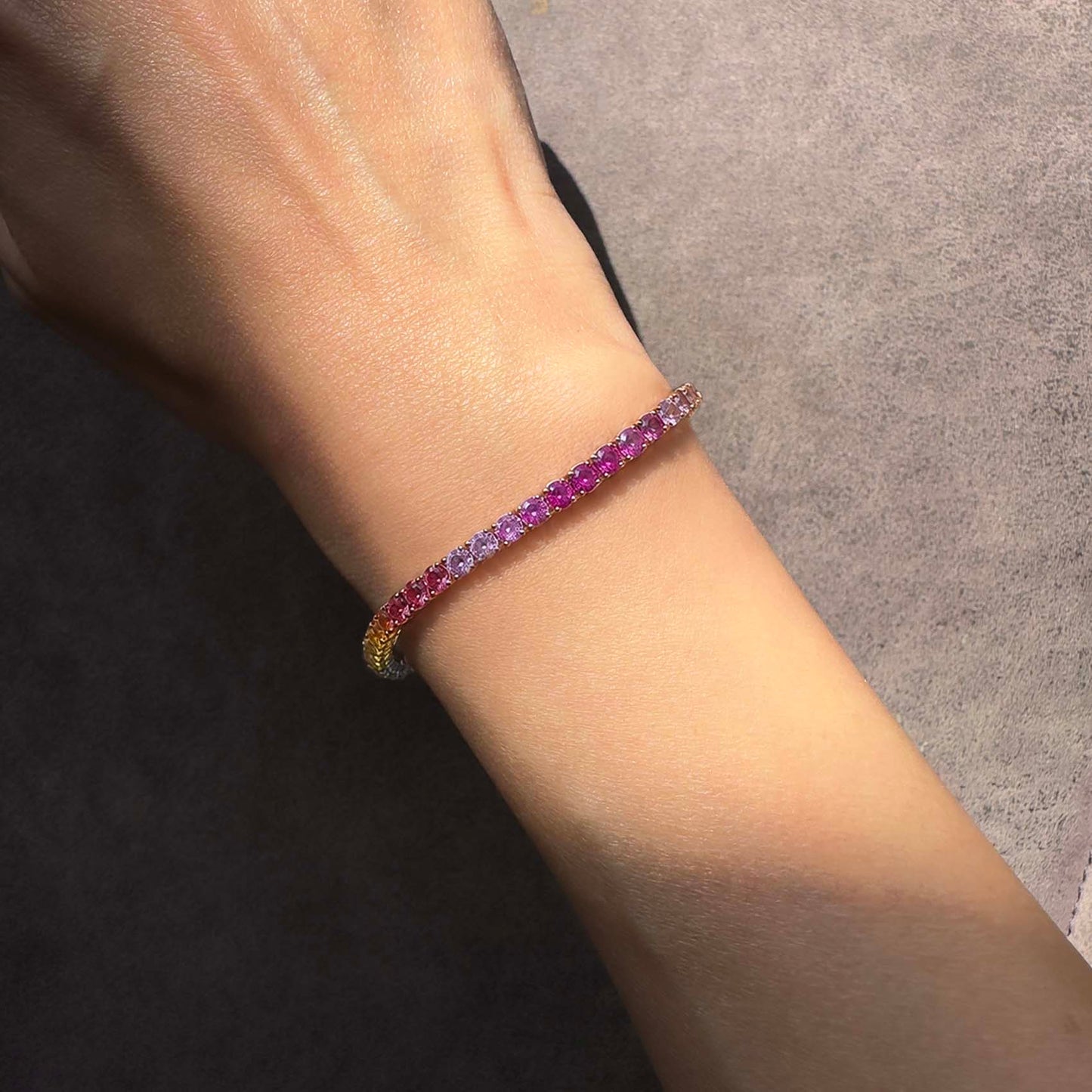 one of a kind 7.8ct rainbow sapphire tennis bracelet in 18k gold on model