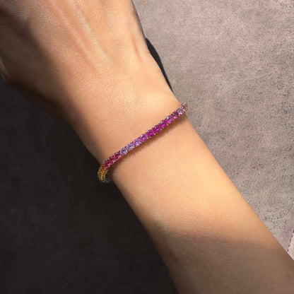one of a kind 7.8ct rainbow sapphire tennis bracelet in 18k gold on model