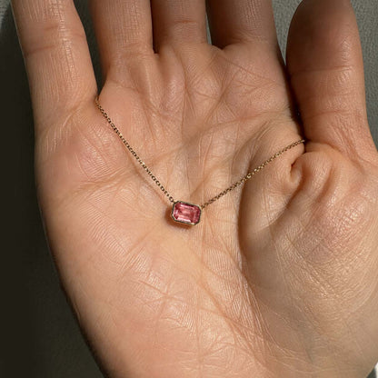 ooak bezel set padparadscha sapphire necklace in 18k gold on hand