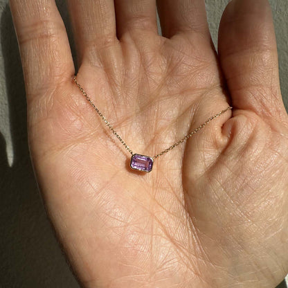 ooak bezel set purple sapphire necklace in 18k gold on hand