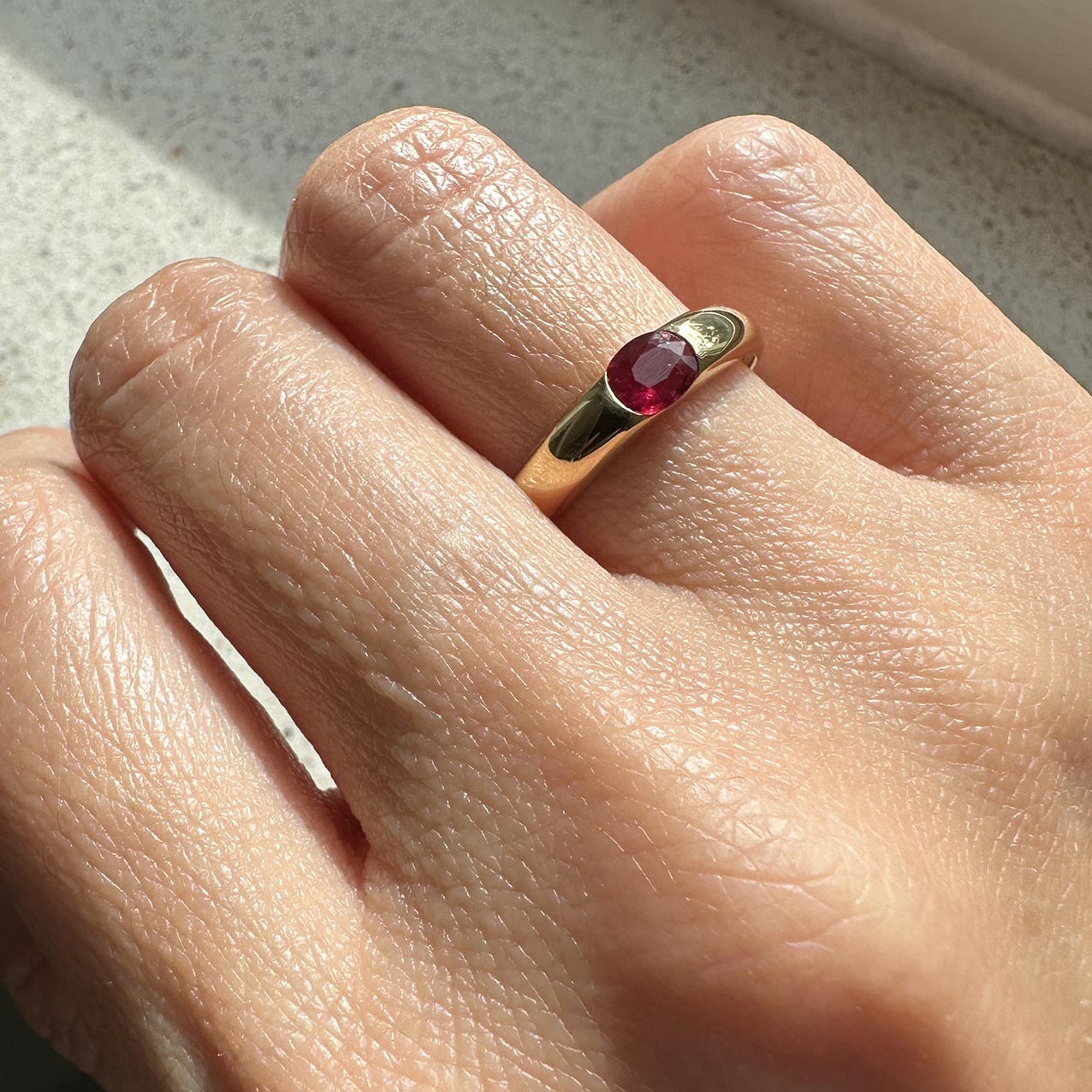 oval ruby ring 18k gold on finger