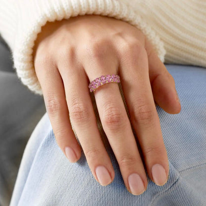 seven stone oval pink sapphire ring in 18k gold on hand