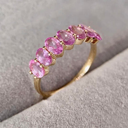 seven stone oval pink sapphire ring in 18k gold side view