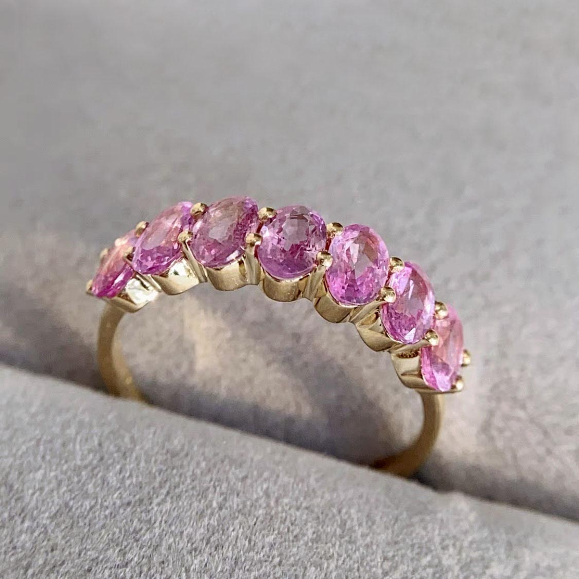 seven stone oval pink sapphire ring in 18k gold side view