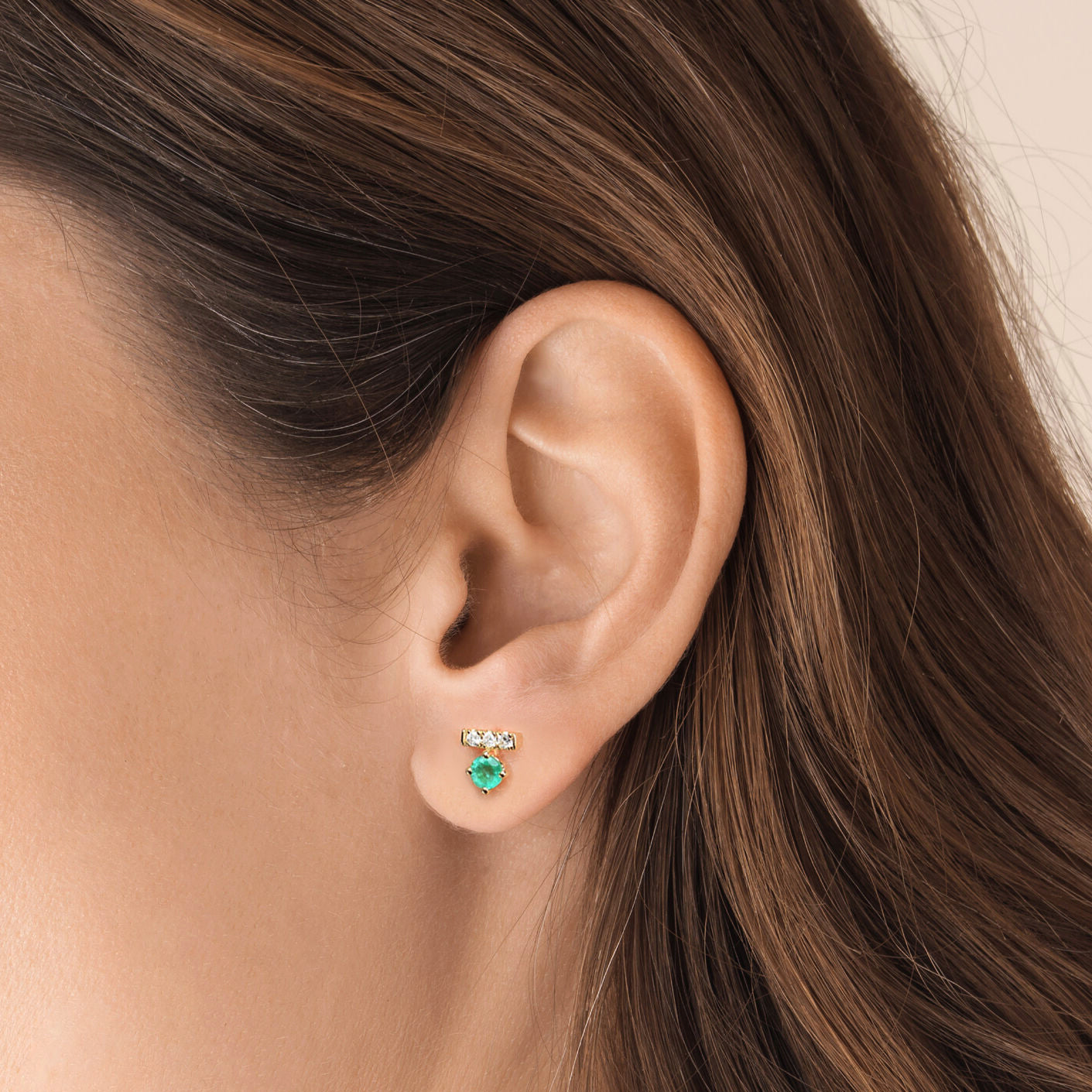 t for tulip emerald and diamond earrings in 18k gold on ear