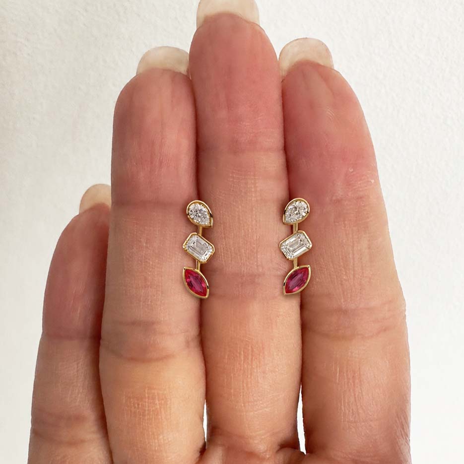 teide fancy cut diamonds and ruby bezel earrings in 18k gold on hand