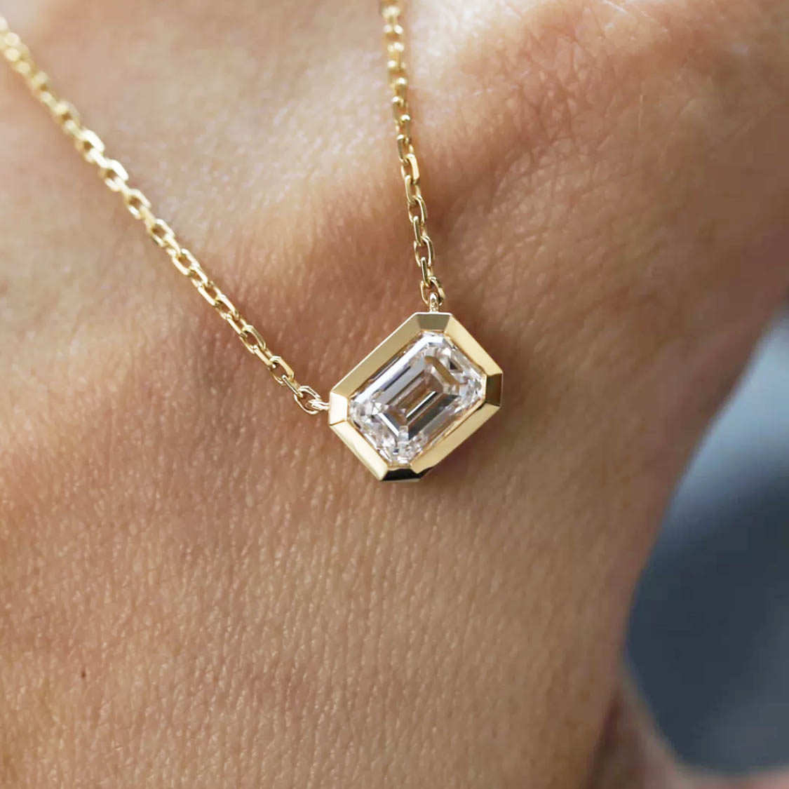 tiede 1ct emerald cut diamond bezel necklace 18k gold on hand