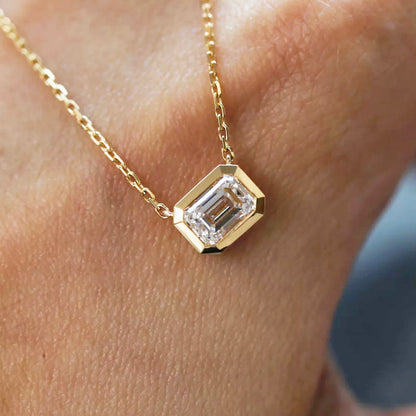 tiede 1ct emerald cut diamond bezel necklace 18k gold on hand