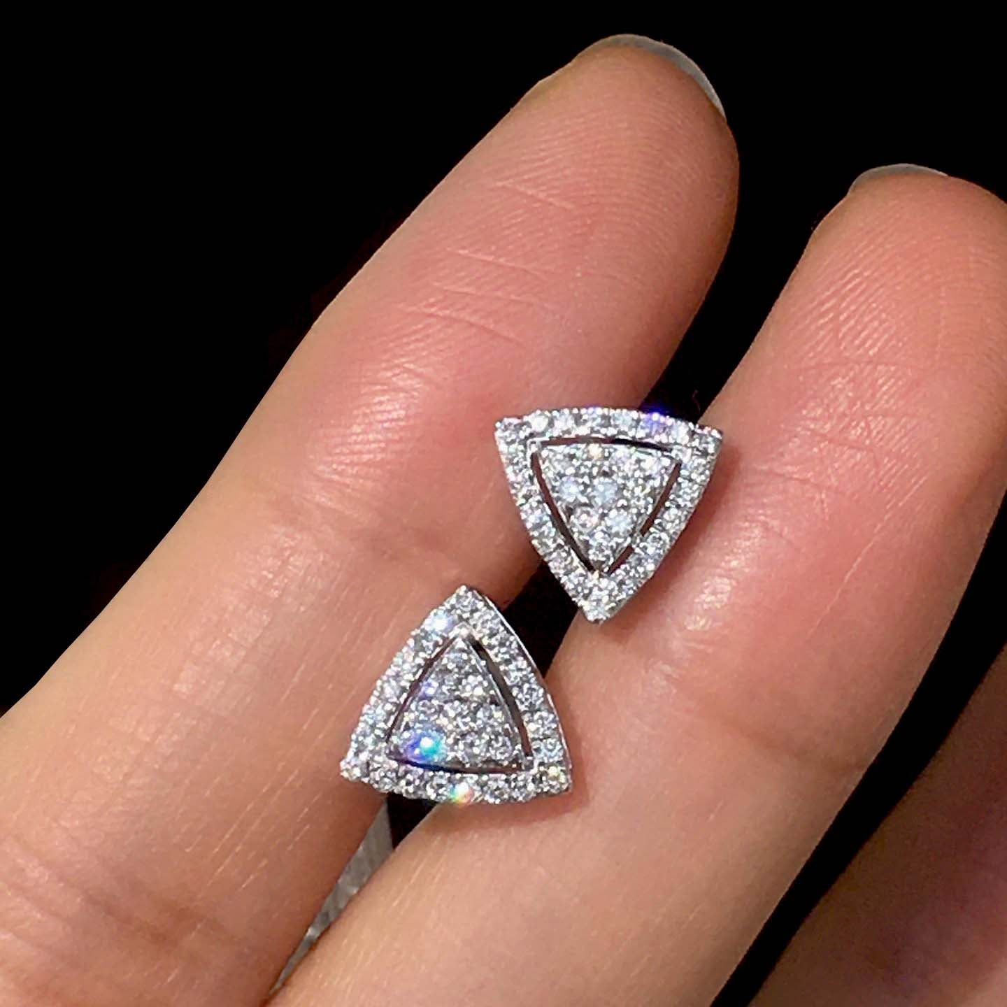 triangle cluster diamond earrings in 18k white gold on hand