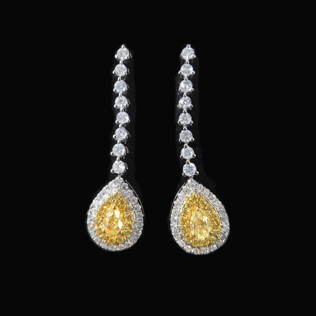 yellow diamond pear earrings in 18k white gold