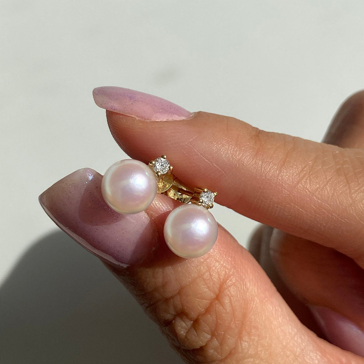 akoya pearl diamond earrings 18k gold on hand