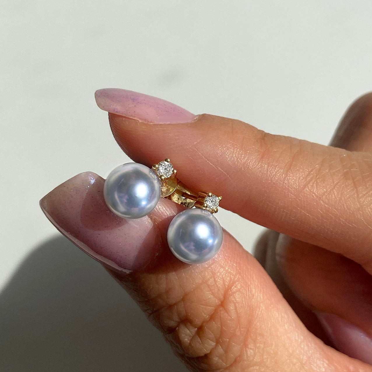 blue akoya pearl diamond earrings 18k gold on hand