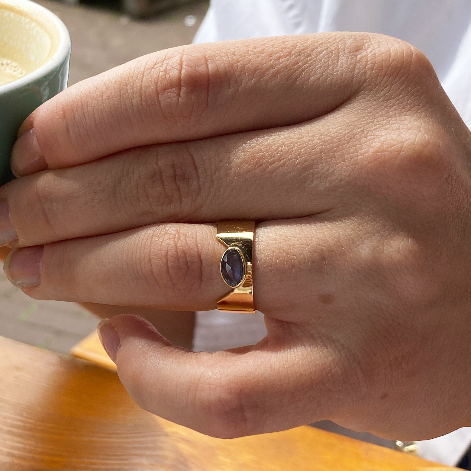 blue sapphire ring 18k gold on finger